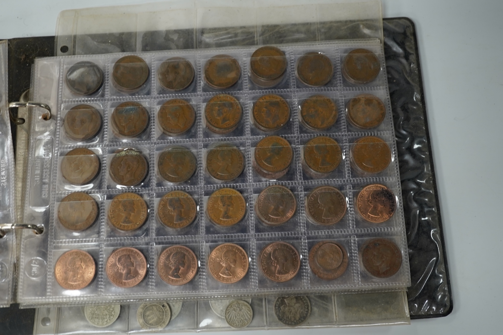 A collection of various coinage in an album, mostly George V to QEII